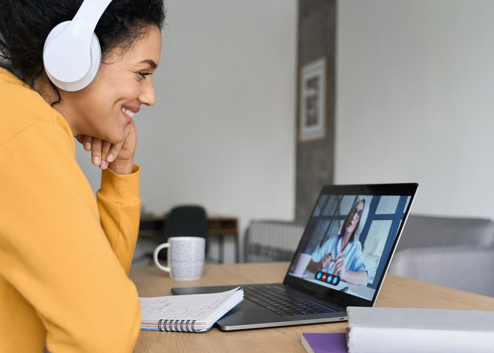 Woman Participating in a Videoconference on Laptop